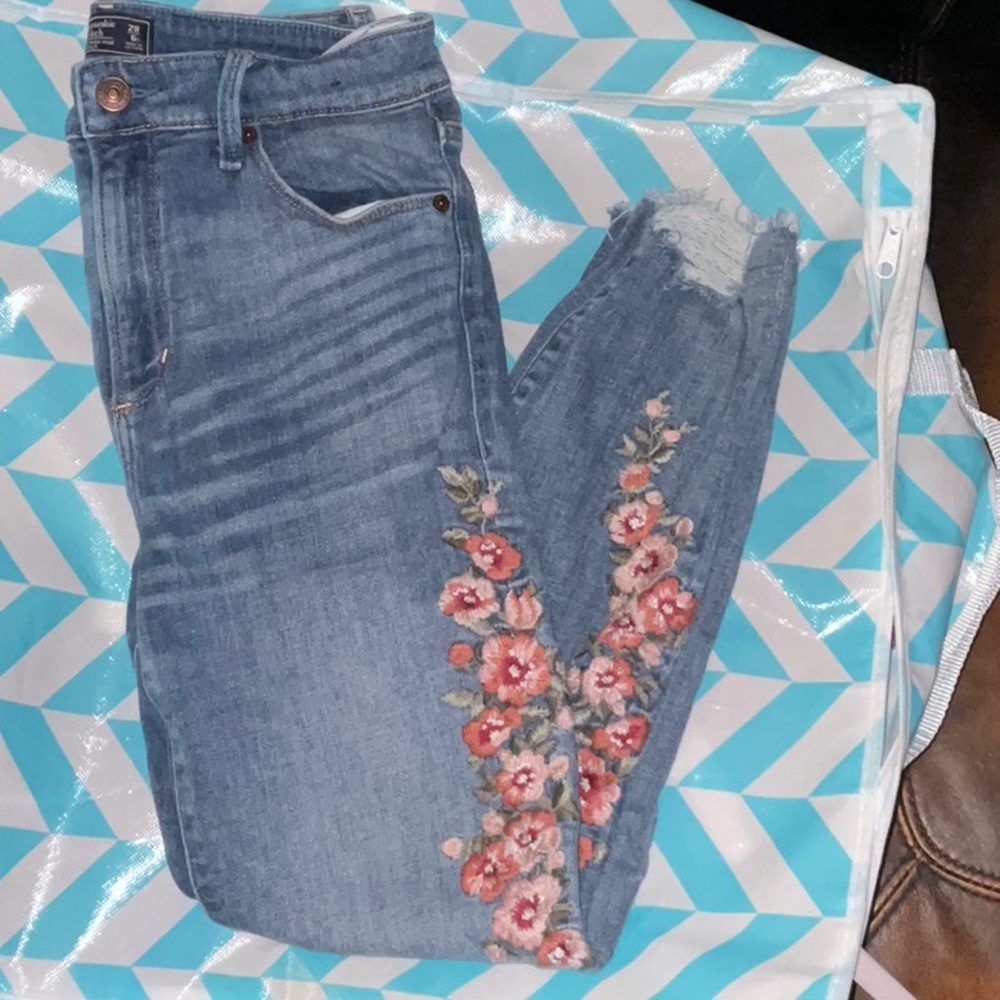 Abercrombie & Fitch embroidered high rise jeans with distressed cropped bottom.